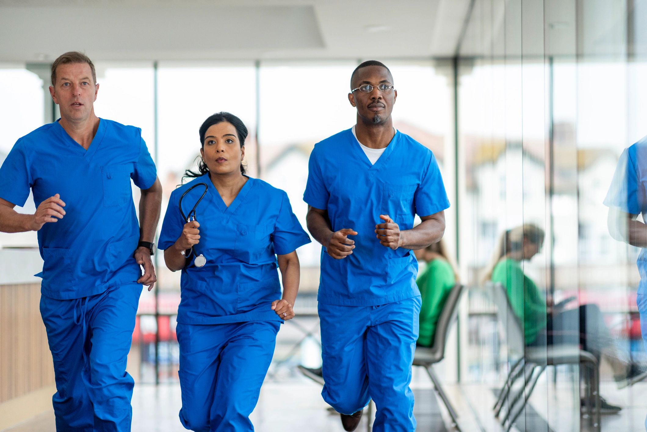 Medical professionals moving through a hospital corridor