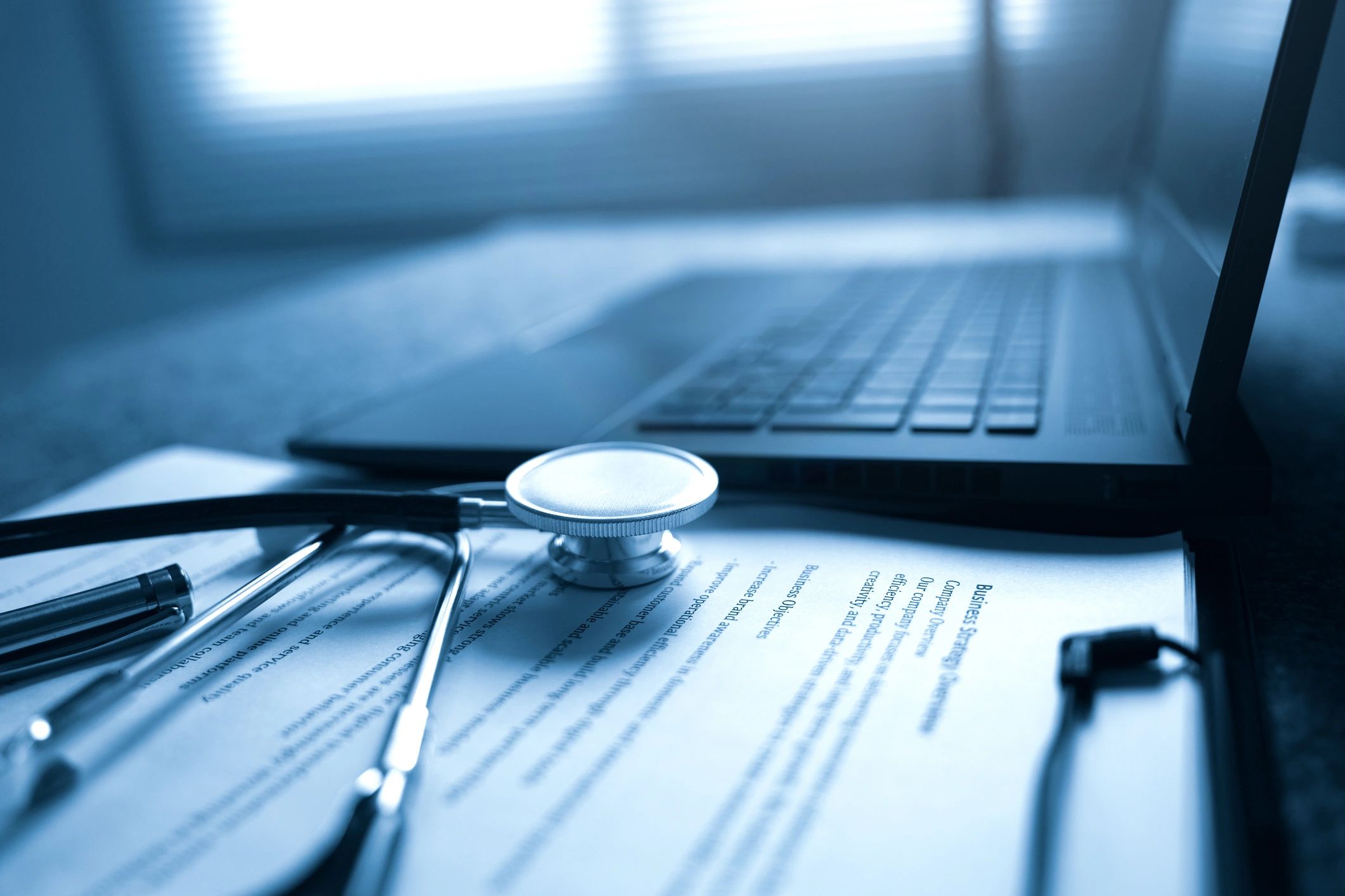 Professional medical workspace with clinical documents and stethoscope
