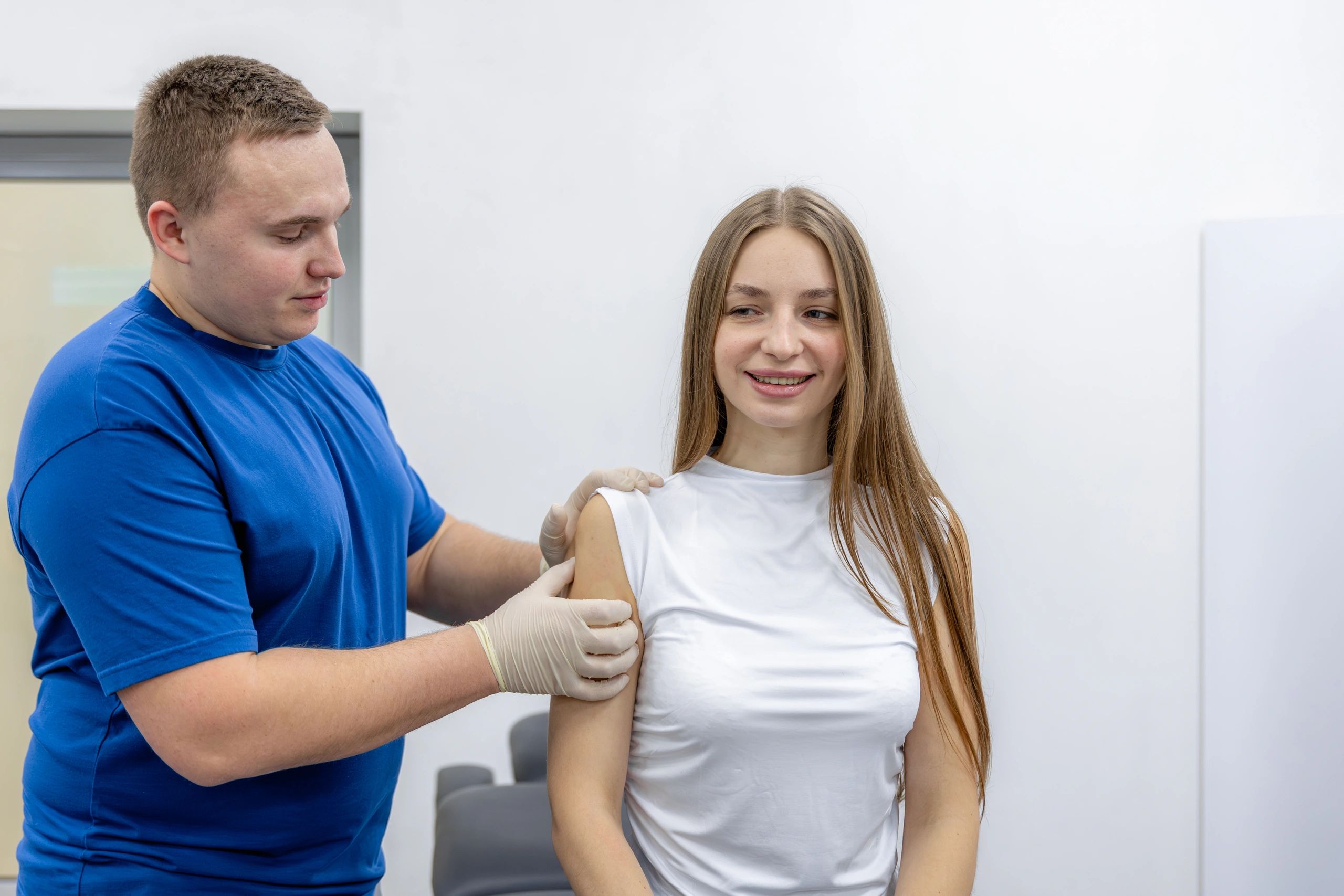 Doctor consulting with a patient in a clinical rehabilitation setting