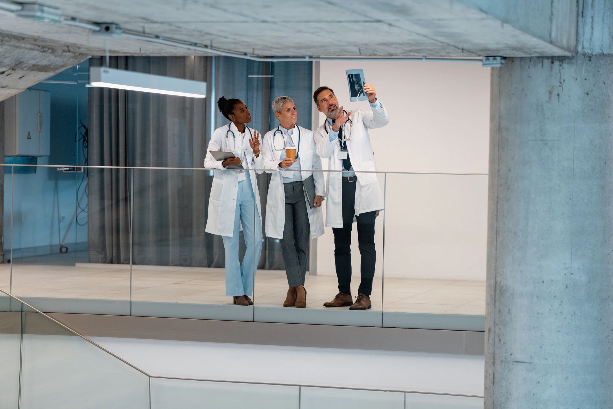 Doctors reviewing imaging together in a hospital corridor